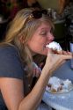 Woman eating a beignet at Cafe Du Monde in the French Quarter of New Orleans, Louisiana, USA.