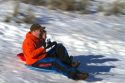 Sledding on a snowy hill near Boise, Idaho, USA.