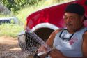 Native hawaiian fisherman mending a net on the island of Kauai, Hawaii, USA. MR