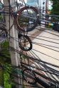 Utility pole with assorted cables and wires in Bangkok, Thailand.