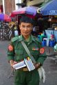 Burmese military veteran in uniform selling books on the street in (Rangoon) Yangon, (Burma) Myanmar.