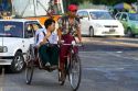 Passengers riding in a trishaw in (Rangoon) Yangon, (Burma) Myanmar.