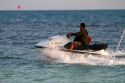 Man riding a personal water craft in the Gulf of Thailand at Chaweng beach on the island of Ko Samui, Thailand.