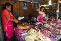 Women chopping and selling meat at an open air market on the island of Ko Samui, Thailand.