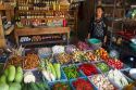Woman selling fresh vegetables and eggs at an open air market on the island of Ko Samui, Thailand.