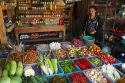 Woman selling fresh vegetables and eggs at an open air market on the island of Ko Samui, Thailand.
