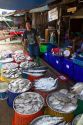 Vendor selling fresh fish at an open air market on the island of Ko Samui, Thailand.