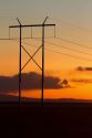 Elecrtic power transmission lines at sunset east of Boise, Idaho, USA.