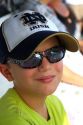 Eight year old boy wearing sunglasses on a fishing trip in the Gulf of Mexico, Florida, USA.