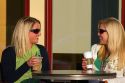 Two female friends having coffee at an outdoor cafe in Tampa, Florida, USA. MR