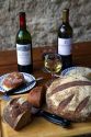 Wine, bread, and pate displayed on a french farm table near Angouleme in southwestern France.
