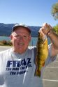 Fisherman displaying his catch of a yellow perch at Lake Cascade in Valley County, Idaho, USA.
