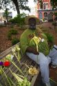 African american man selling river street roses weaved from palm fronds in Savannah, Georgia, USA.