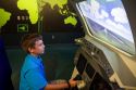 Boy using a flight simulator at the John F. Kennedy Space Center, Merritt Island, Florida, USA.