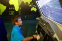 Boy using a flight simulator at the John F. Kennedy Space Center, Merritt Island, Florida, USA.