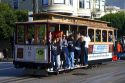Passengers ride a cable car in San Francisco, California, USA.