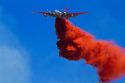 Lockheed P2V-5 Neptune Fire bomber dropping retardant on a wildfire in Idaho, USA.