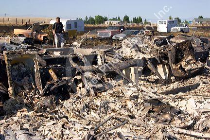 Victims sift through the rubble of a home destroyed by wildfire near Mountain Home, Idaho.