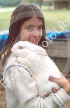 Young girl holding a pet rabbit.  MR