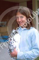 Young girl holding a pet rabbit. MR