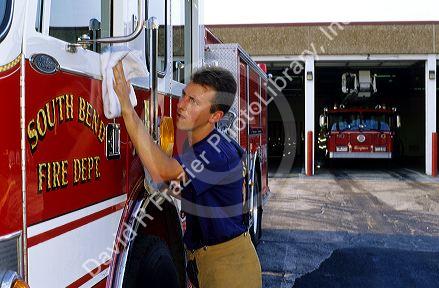 Firefighter polishing a fire truck in South Bend, Indiana.