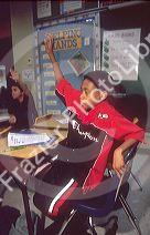 African American boy raising his hand in an Elementary school classroom. MR