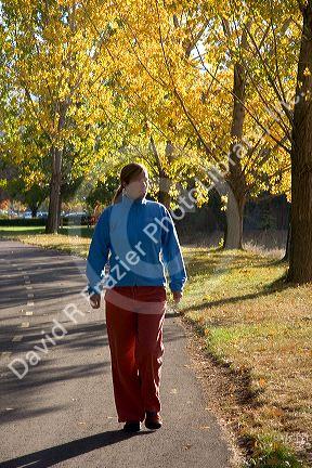 A woman walking alone on the greenbelt in Boise, Idaho. MR
