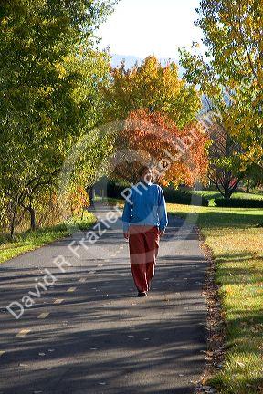 A woman walking alone on the greenbelt in Boise, Idaho. MR