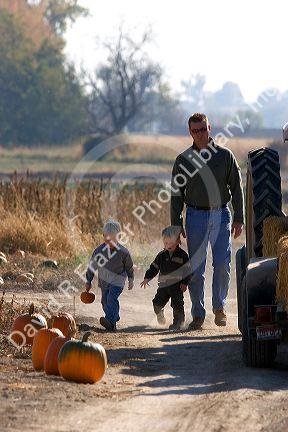 Father and sons at a pumpkin farm in Fruitland, Idaho.