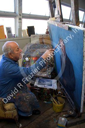 An artist painting a portrait on canvas in Boise, Idaho. MR