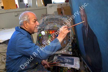 An artist paints a portrait on canvas in Boise, Idaho. MR