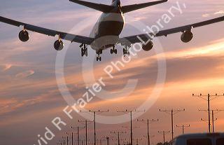 Boeing 747 landing at LAX airport in Los Angeles at sunset.