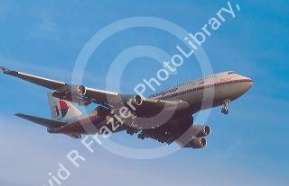 Maylaysia airline Boeing 747 landing at dusk.