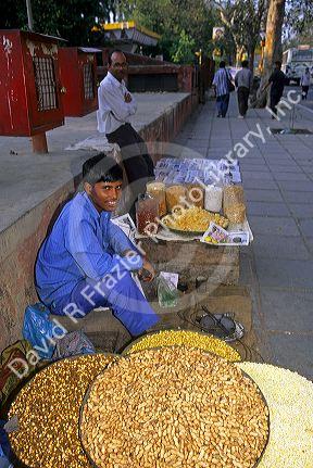 A street vendor in New Delhi India selling nuts.