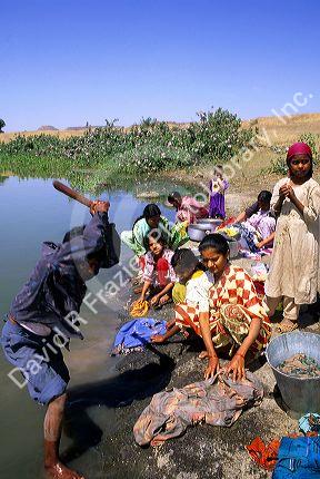 Indian villagers wash clothes on the plains of India.