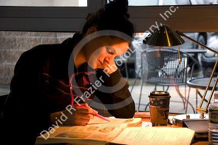 Female college student studying at a coffee shop in Boise, Idaho. MR