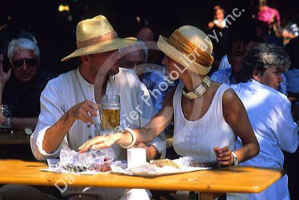 A German couple eat lunch at Biergarten, Germany.