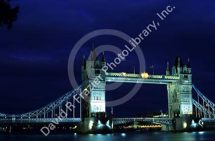 The Tower Bridge across the River Thames at night in London, England.