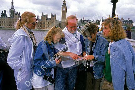 American tourists look at a map in London, England.