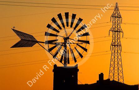 A windmill and power lines in Majorca, Spain.