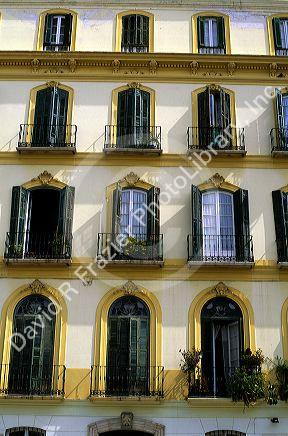 A building with shuttered windows at Plaza Merced housing Pablo Picasso's birthplace in Malaga, Spain.