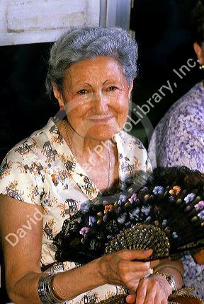 A spanish woman fanning herself in Madrid, Spain.