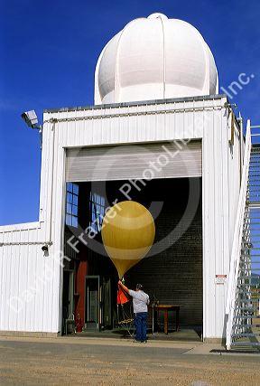 Meteorologist getting ready to launch a weather balloon.
