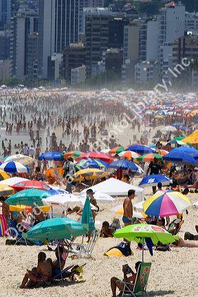 Crowded beach scene at the Copacabana Beach in Rio de Janeiro, Brazil.