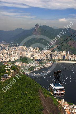 View of Rio de Janeiro and a cable car on Sugarloaf Peak, Brazil.