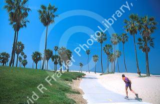 Woman rollerblading along Venice Beach, California.