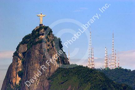 Christ statue in Rio de Janeiro, Brazil contrasts with broadcast radio and television antennae.