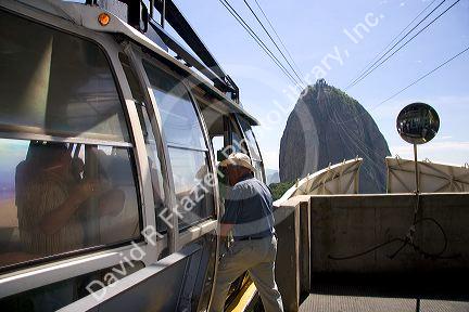 Man entering a cable car to the top of Sugarloaf Peak in Rio de Janeiro, Brazil.