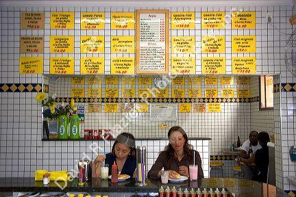 People eat at a lanchanette, cafe, restaurant in the Liberdade asian section of Sao Paulo, Brazil.