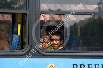 Brazilian boys riding a bus in Manaus, Brazil.